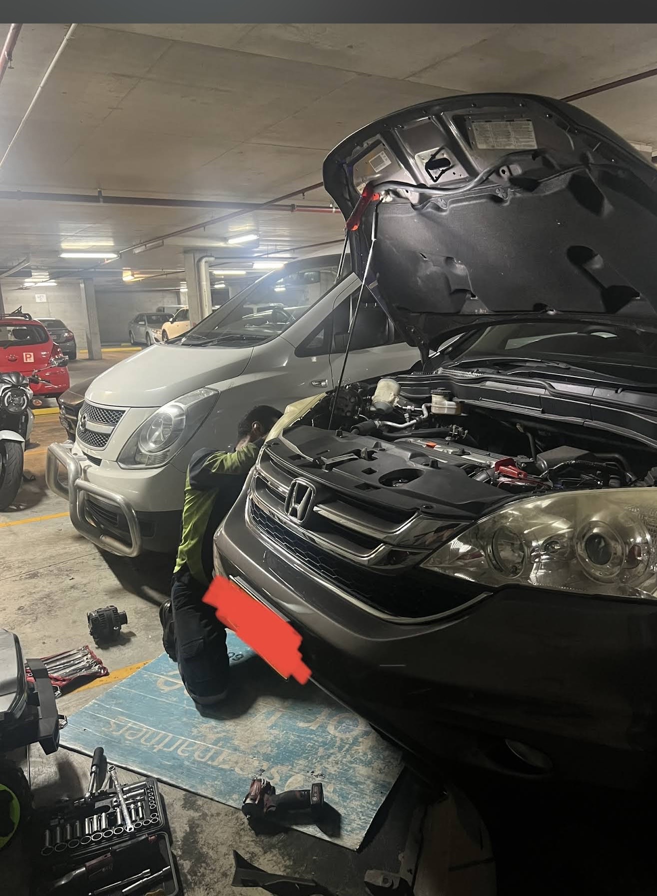 Mehdi servicing a Honda CR-V in an undercover carpark in Parramatta